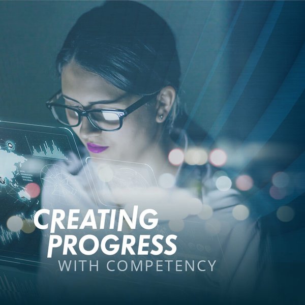 Image of a woman looking at graphics, with the inscription Creating Progress with Competency.