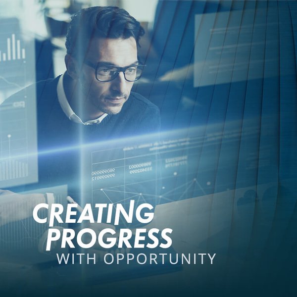 Bild von einem Mann der auf Grafiken sieht mit der Aufschrift Creating Progress with Opportunity.